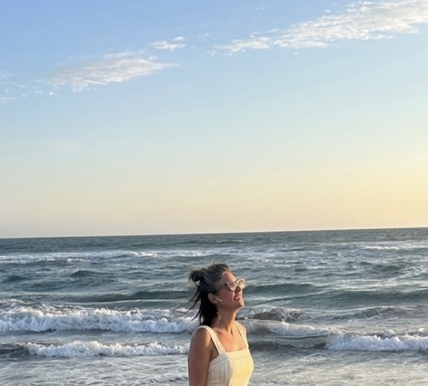Marisa Cherry, LCSW, on the beach at golden hour